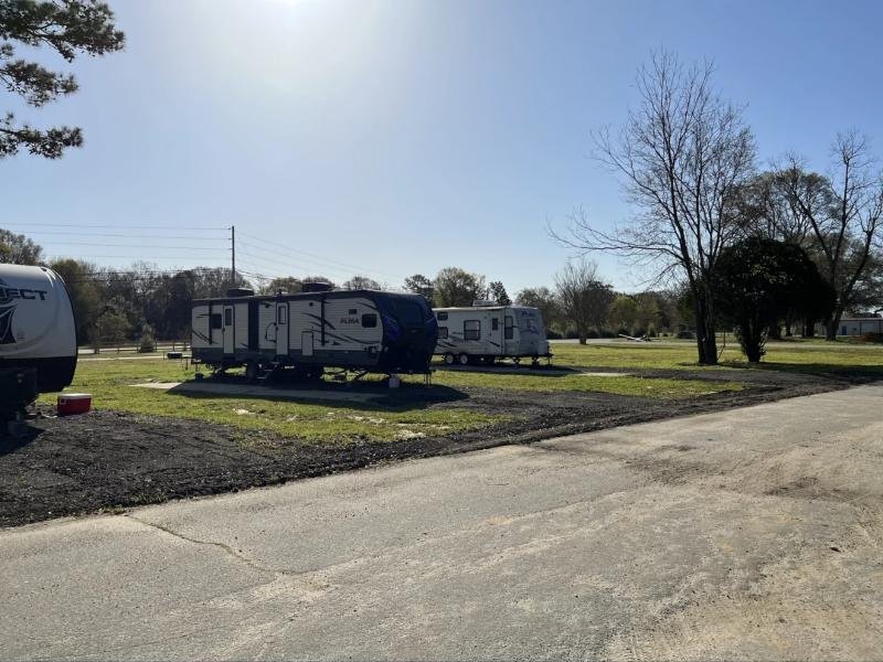 Travel trailers parked on back-in pads at Cedar Trail