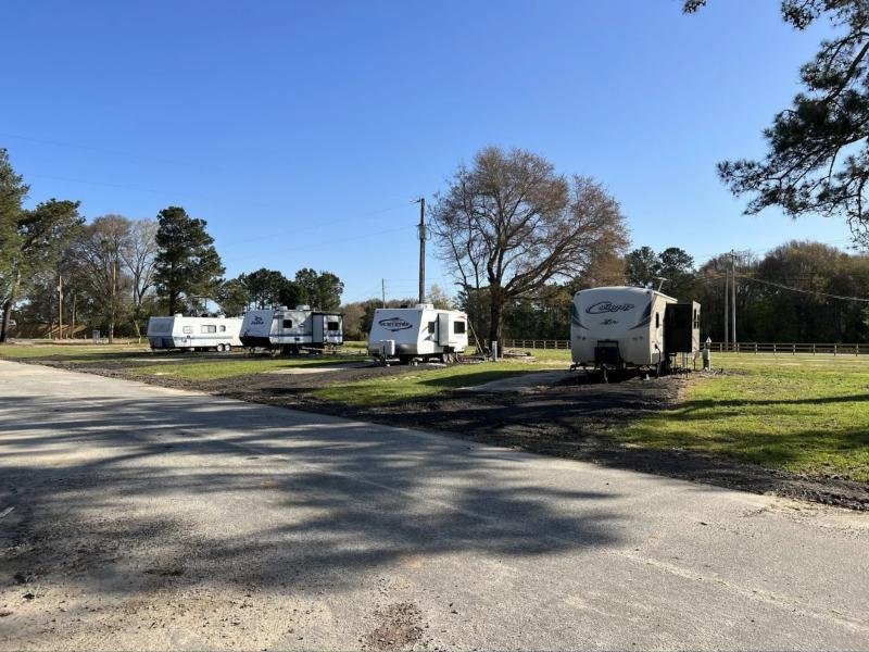 Back-in RV sites along a paved road at Cedar Trail RV Park